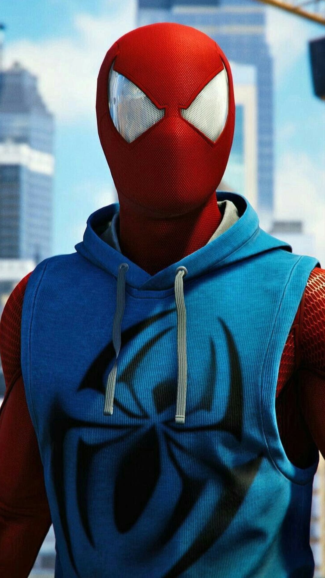 Scarlet Spider in a blue sleeveless hoodie with a black logo stands before blurred skyscrapers and a blue sky.