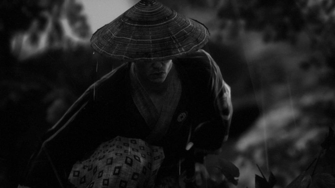 Samurai wearing a conical hat in the rain with a dark patterned kimono in a monochrome cinematic scene.