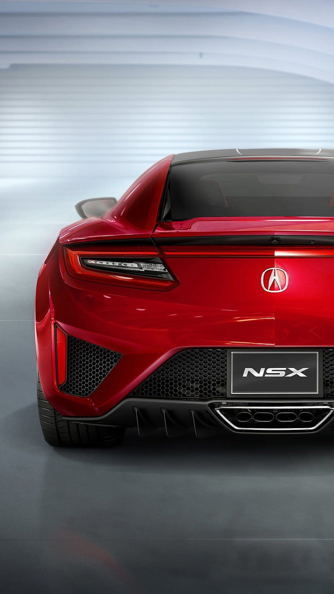 Red Acura NSX rear view with glowing LED taillights and quad exhausts in a minimalist modern garage.