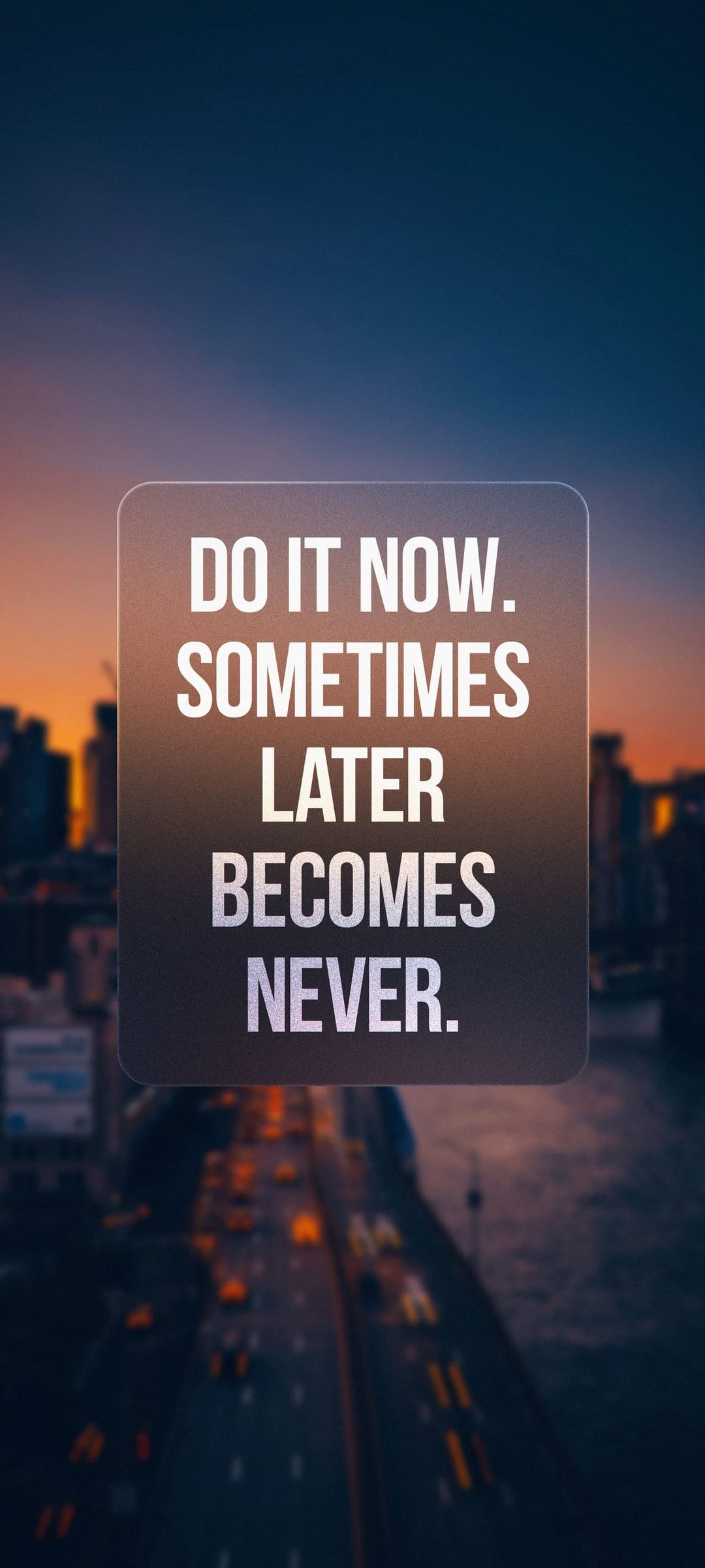 Motivational white text stating Do It Now against a blurred urban night background with glowing traffic lights.