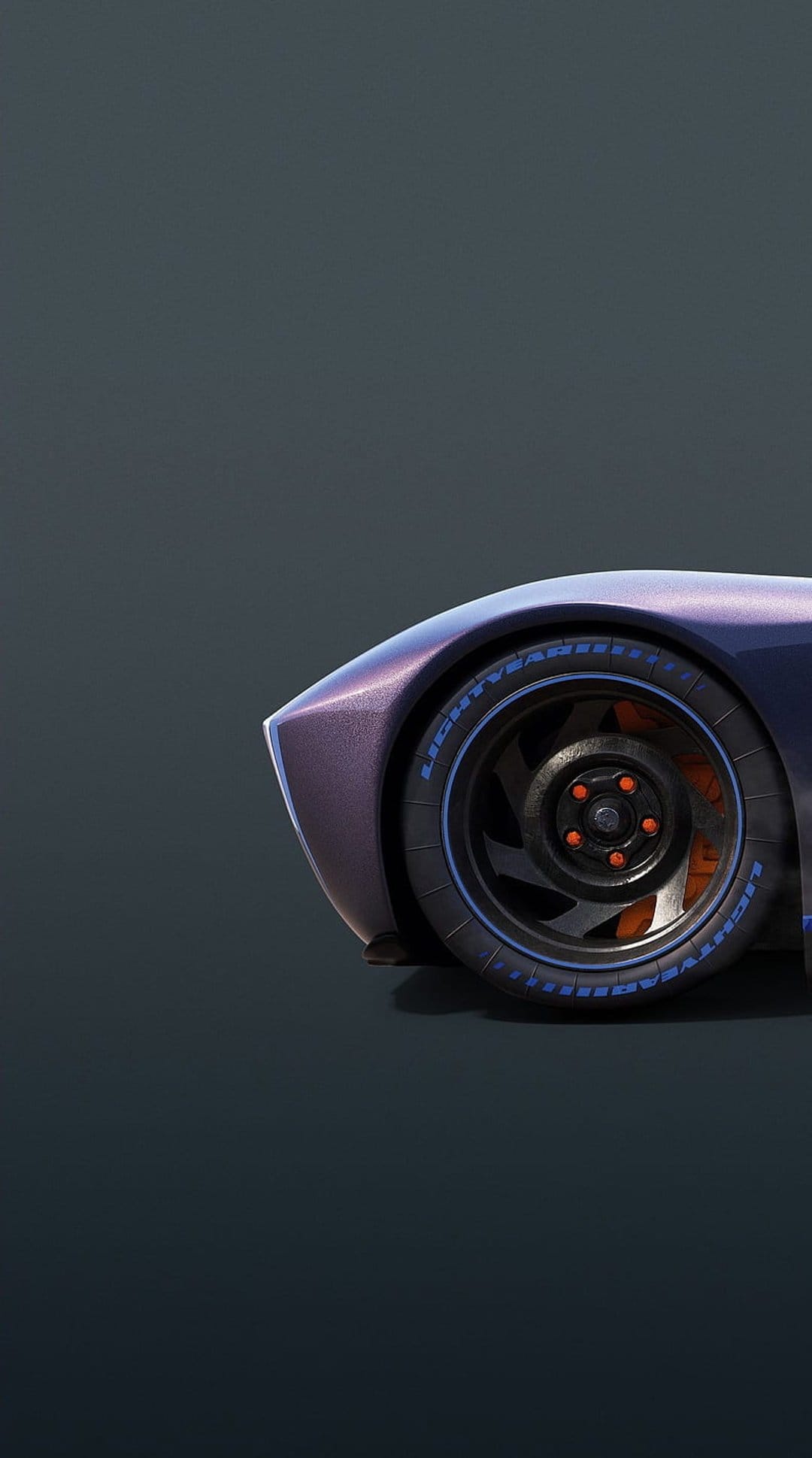 Metallic purple car fender over a black rim with orange brake calipers and blue lettering on the tire sidewall.