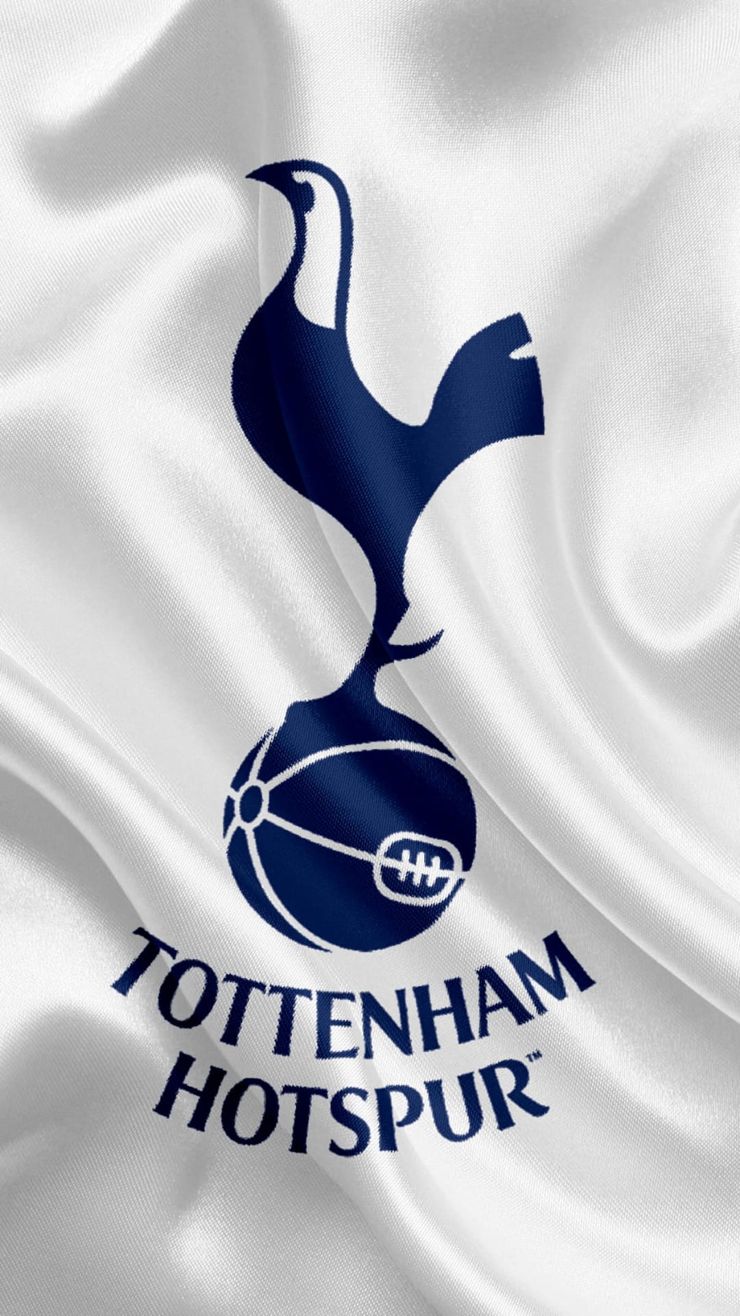 Navy blue Tottenham Hotspur cockerel crest and club name centered on a flowing white satin fabric background.