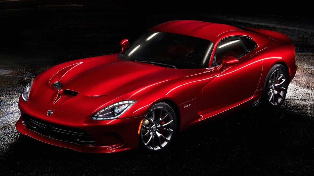 Red Dodge Viper GTS sports car with metallic paint and LED headlights against a dark studio background.