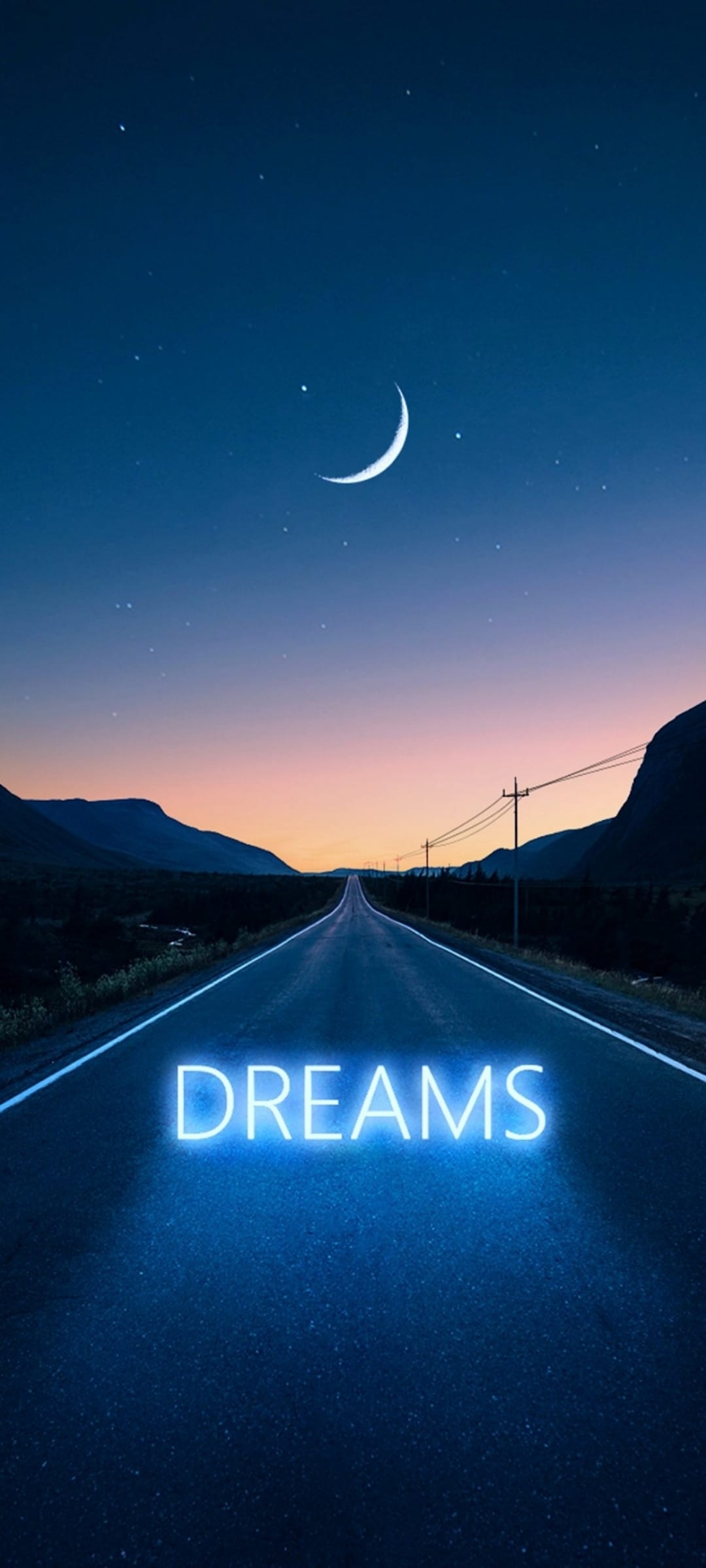 Blue neon text spelling dreams on a dark asphalt road under a crescent moon and many twinkling stars at night.