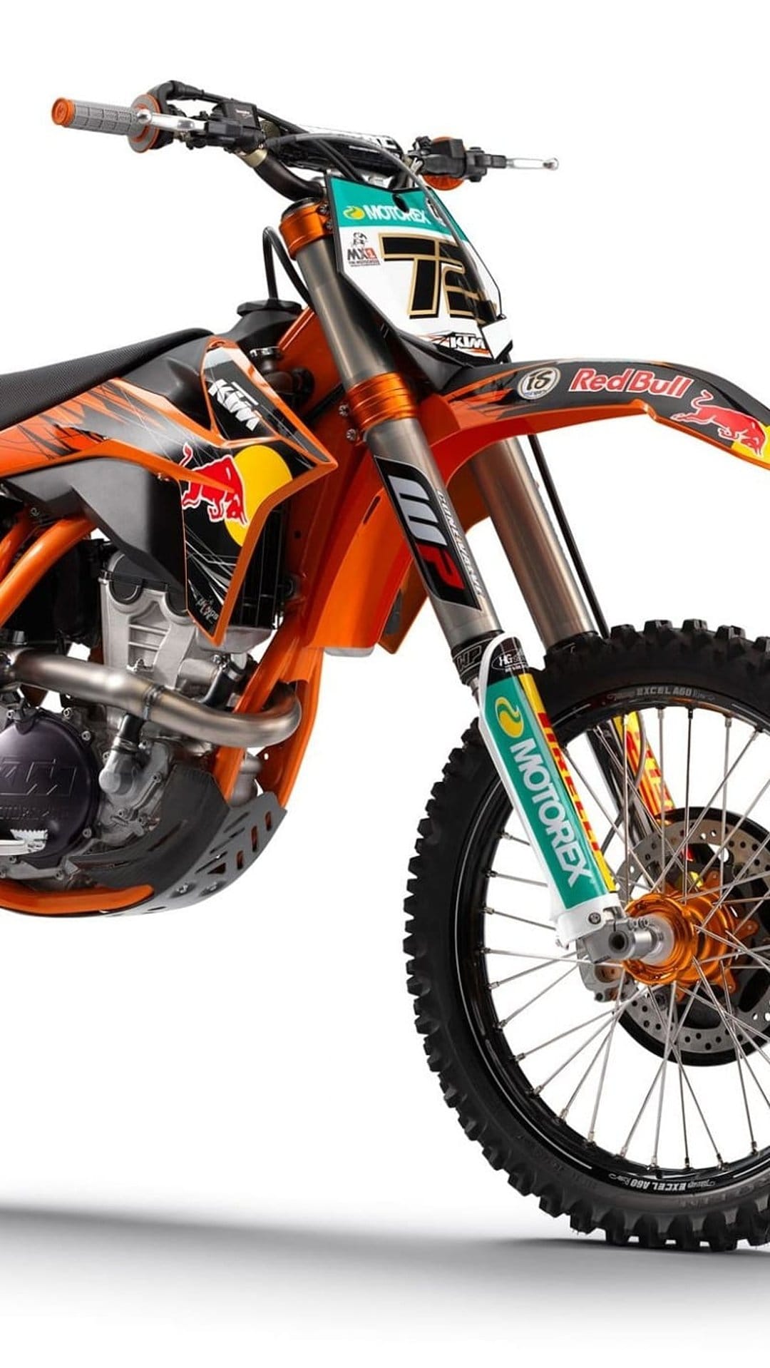 KTM motocross bike featuring Red Bull graphics, number 75 plate, and exposed engine parts in a vertical view.