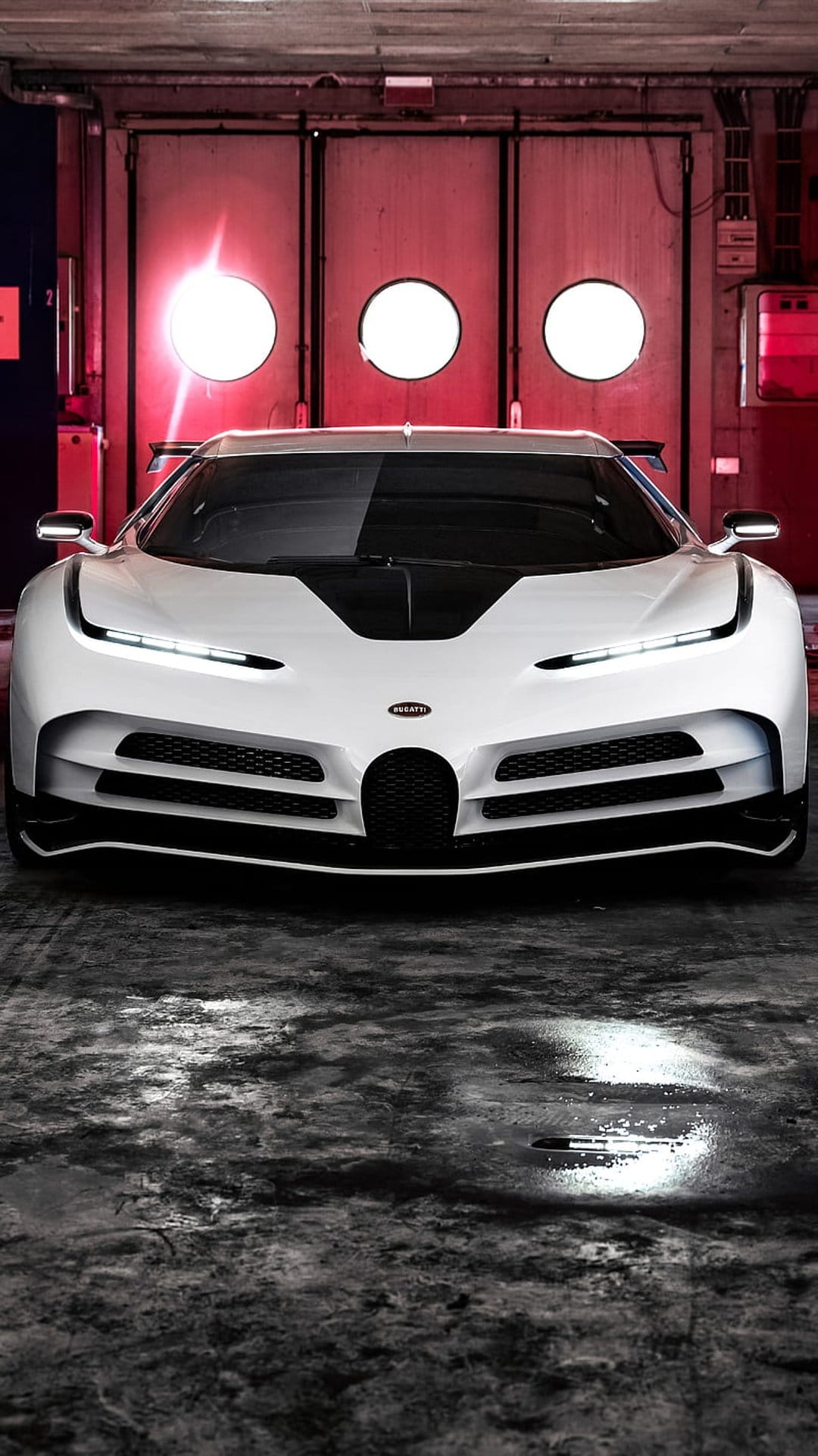 White Bugatti Centodieci hypercar on a wet garage floor with glowing red circular lights in the background.