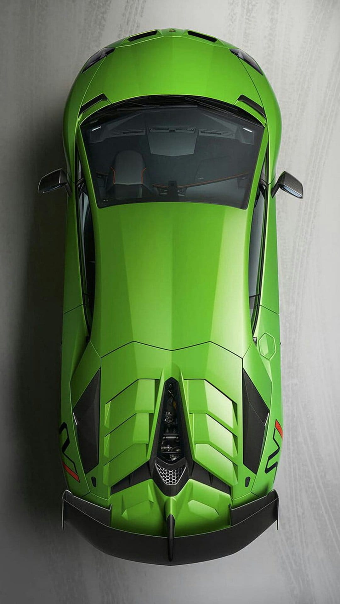 Lime green Lamborghini Aventador SVJ from a top-down view showing the roof, hood vents, and large rear spoiler.