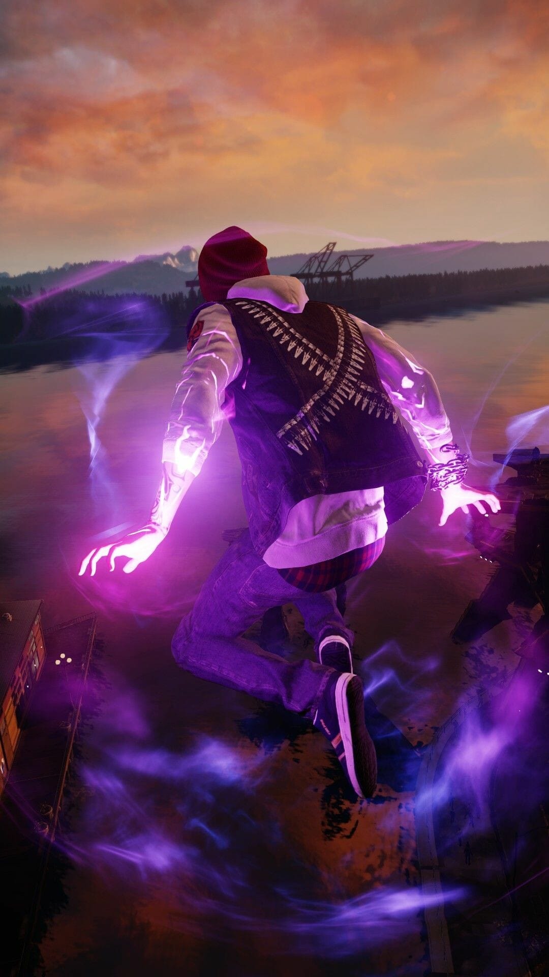 Man in a denim vest jumping with glowing purple energy trails around his arms during a sunset over dark water.