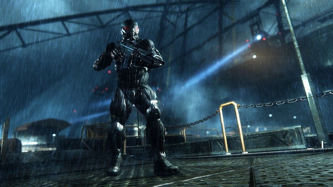 Armored soldier in a Nanosuit holding a rifle on a rainy industrial pier under a bright blue searchlight.