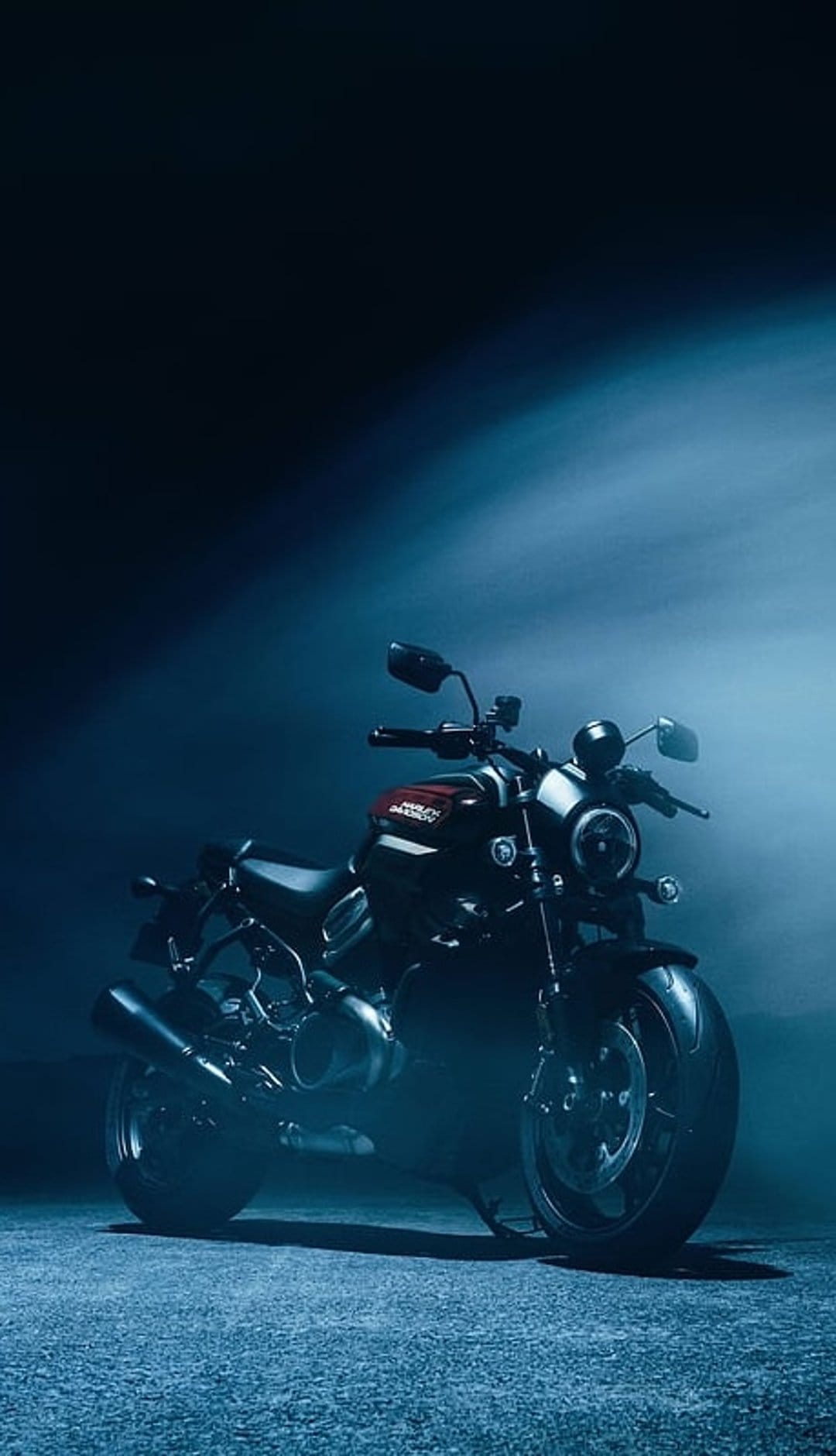 Harley-Davidson cruiser silhouetted against glowing blue smoke with visible engine details and chrome rims.
