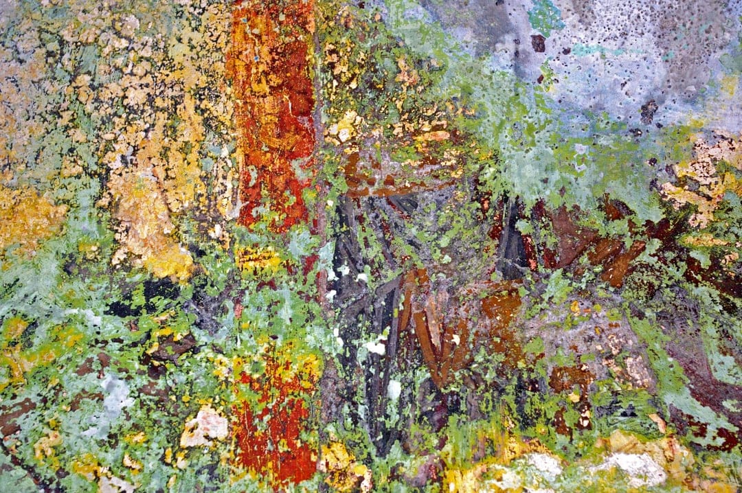 Verdigris-coated copper surface features crusty turquoise patina, orange rust spots, and charcoal gray metallic flaking.