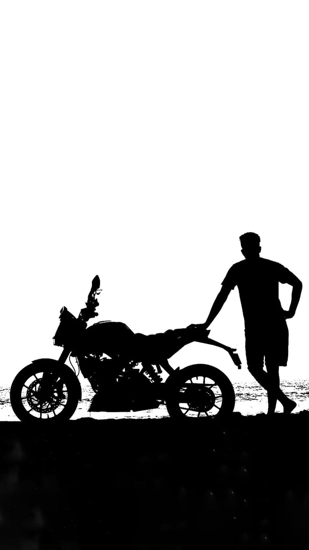 Man leaning on a motorcycle at the beach during sunset, rendered as a high-contrast black and white silhouette.