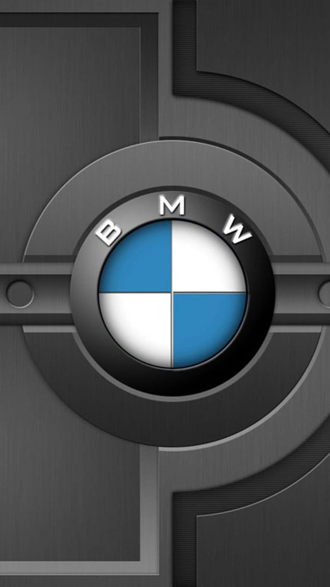 BMW emblem with blue and white quadrants centered on a dark grey brushed metal texture with subtle highlights.