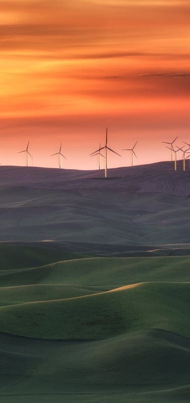 Wind turbines, sunset, nature, landscape, renewable energy, peaceful, serene, tranquil, beautiful, outdoor, sky, vibrant, green, hills, clean energy, dawn, dusk, technology, environment, sustainable