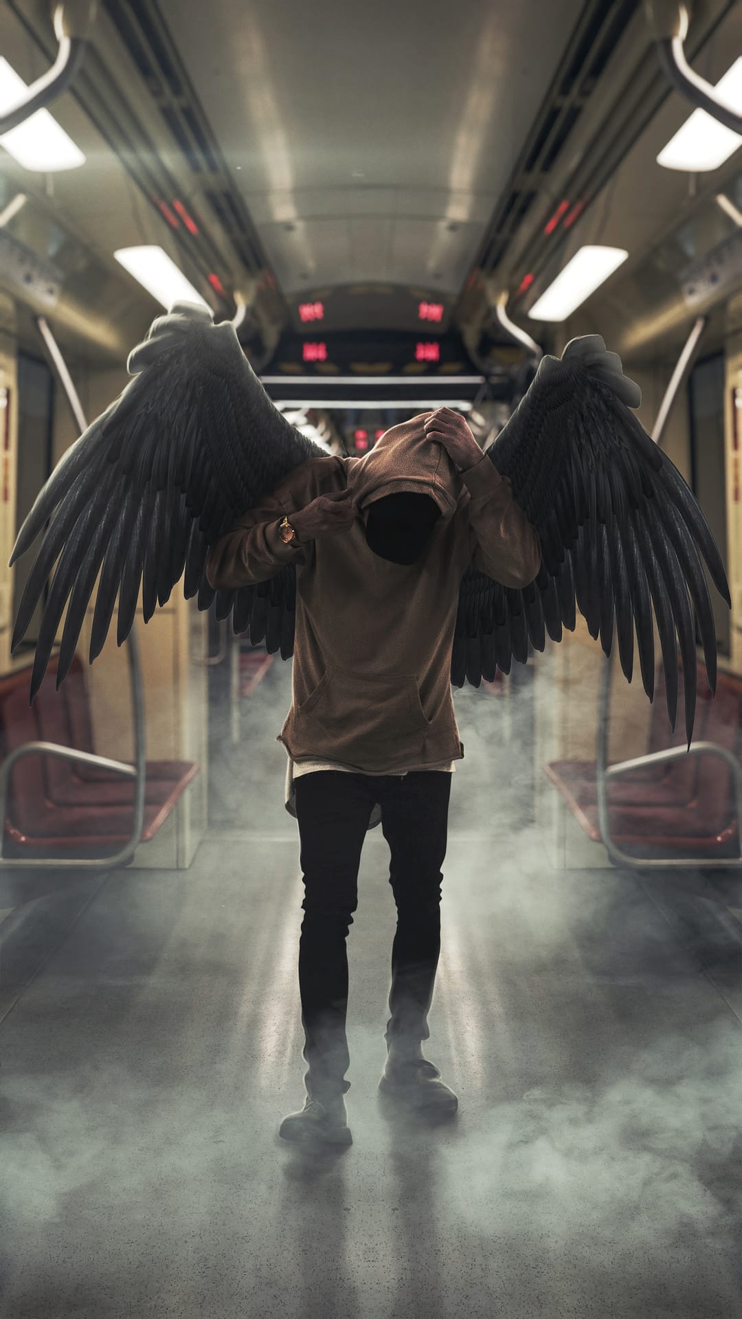 Hooded figure with large black wings stands inside a hazy subway car with hands covering their face.