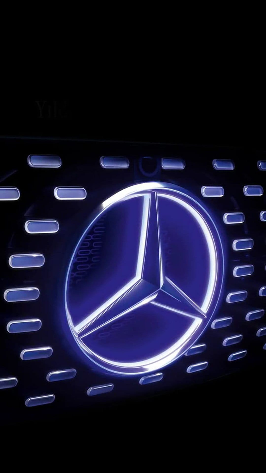 Mercedes-Benz star emblem glowing blue on a dark horizontal slatted vehicle grille in a close-up shot.