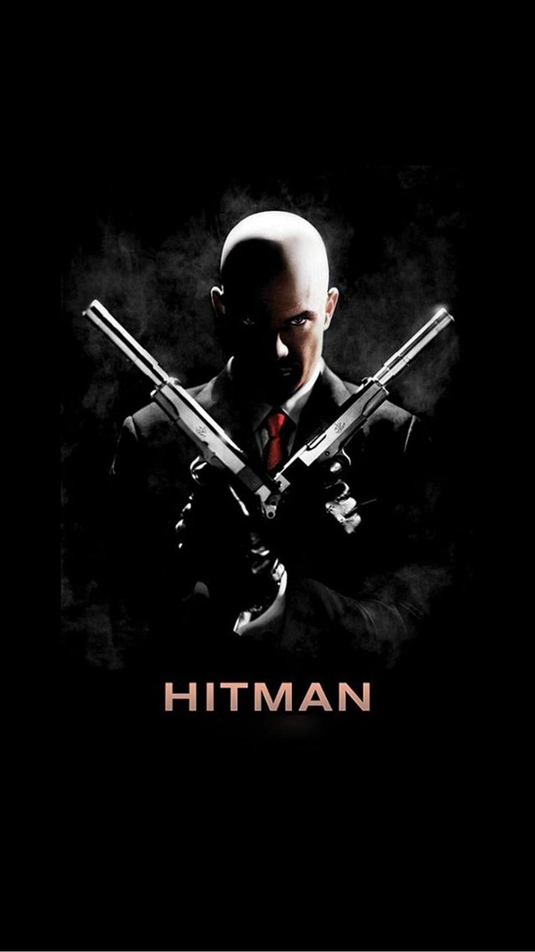 Agent 47 in a black suit holding crossed silver silenced pistols against a dark smoky background with a red tie.