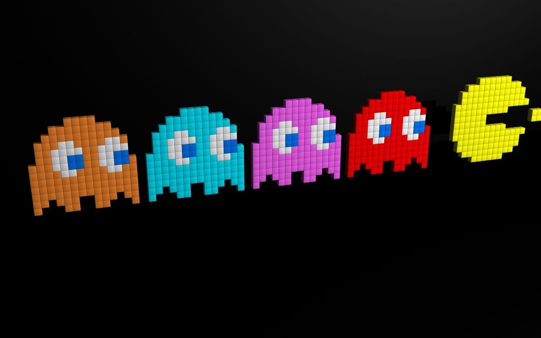 Pac-Man and four pixelated 3D ghosts in orange, cyan, pink, and red on a black landscape background.