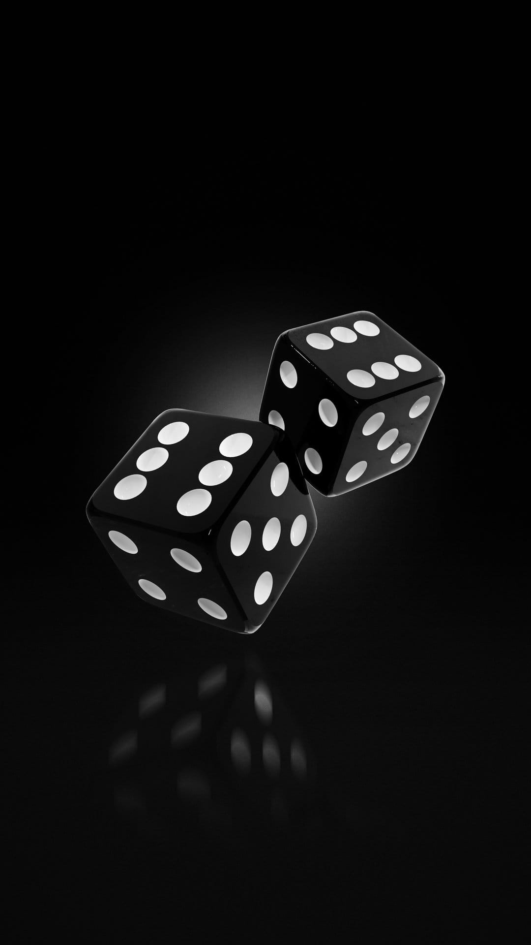 Black glossy dice with white dots floating in mid-air against a dark background with subtle surface reflections.