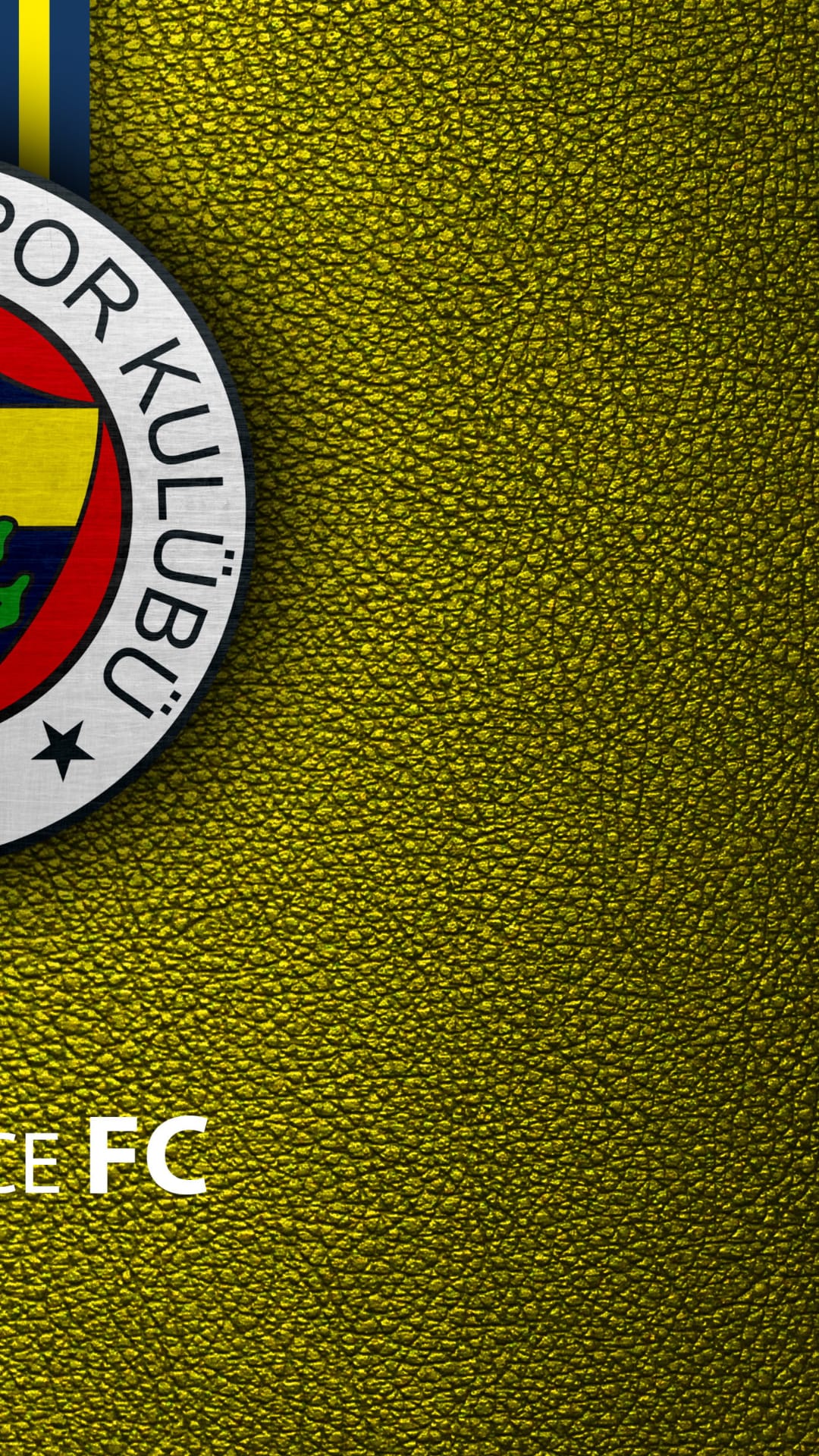 Fenerbahce SK football crest with a gold star rests on a metallic yellow leather textured surface in a close-up.