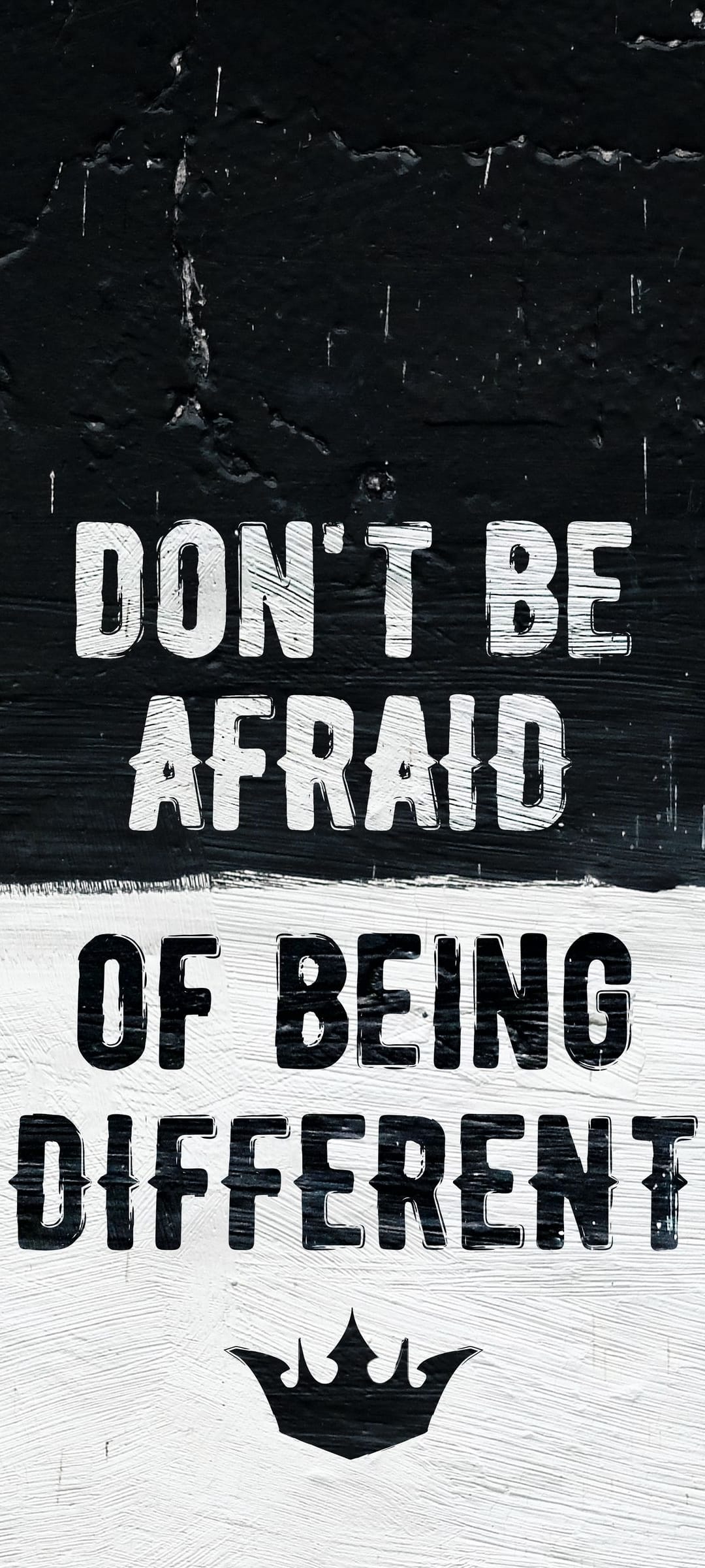 Motivational quote text Don't Be Afraid Of Being Different with a small crown on a dark textured background.