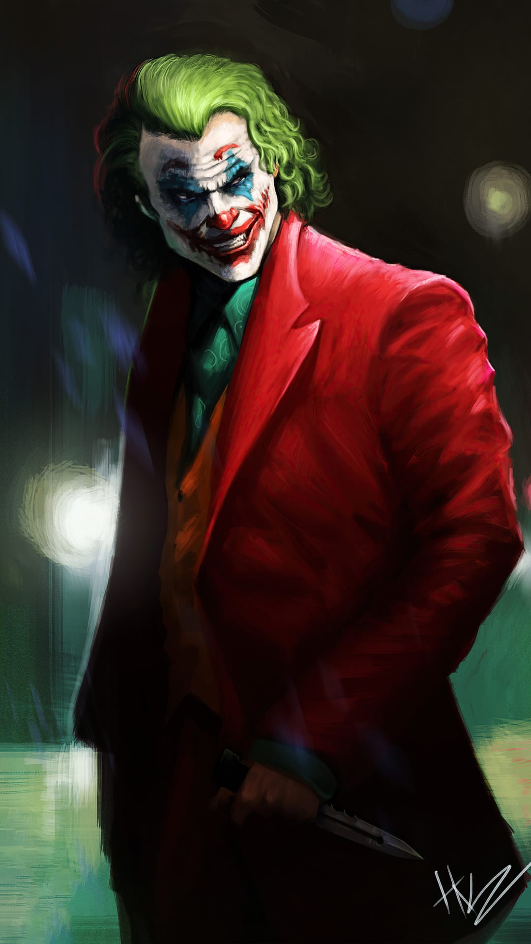 Joker in a red suit with green hair and clown makeup stares intensely while holding a sharp silver knife.