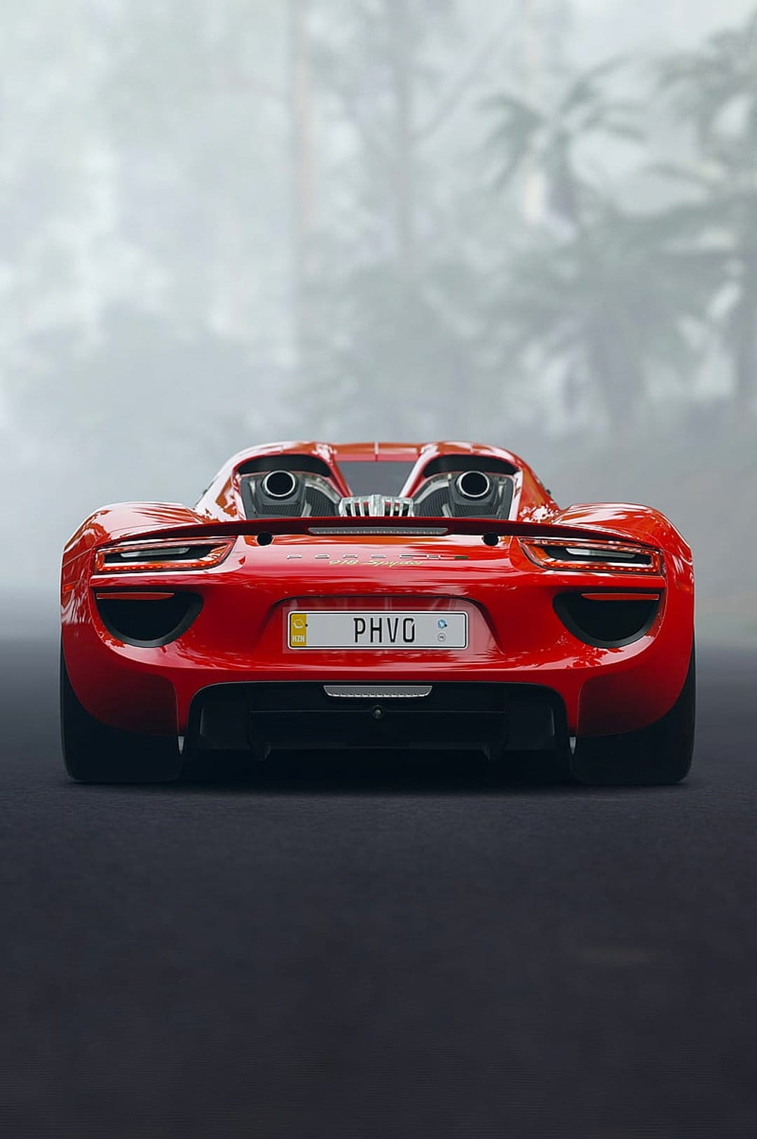 Red Porsche 918 Spyder rear view featuring high exhaust pipes and slim taillights against a foggy forest backdrop.