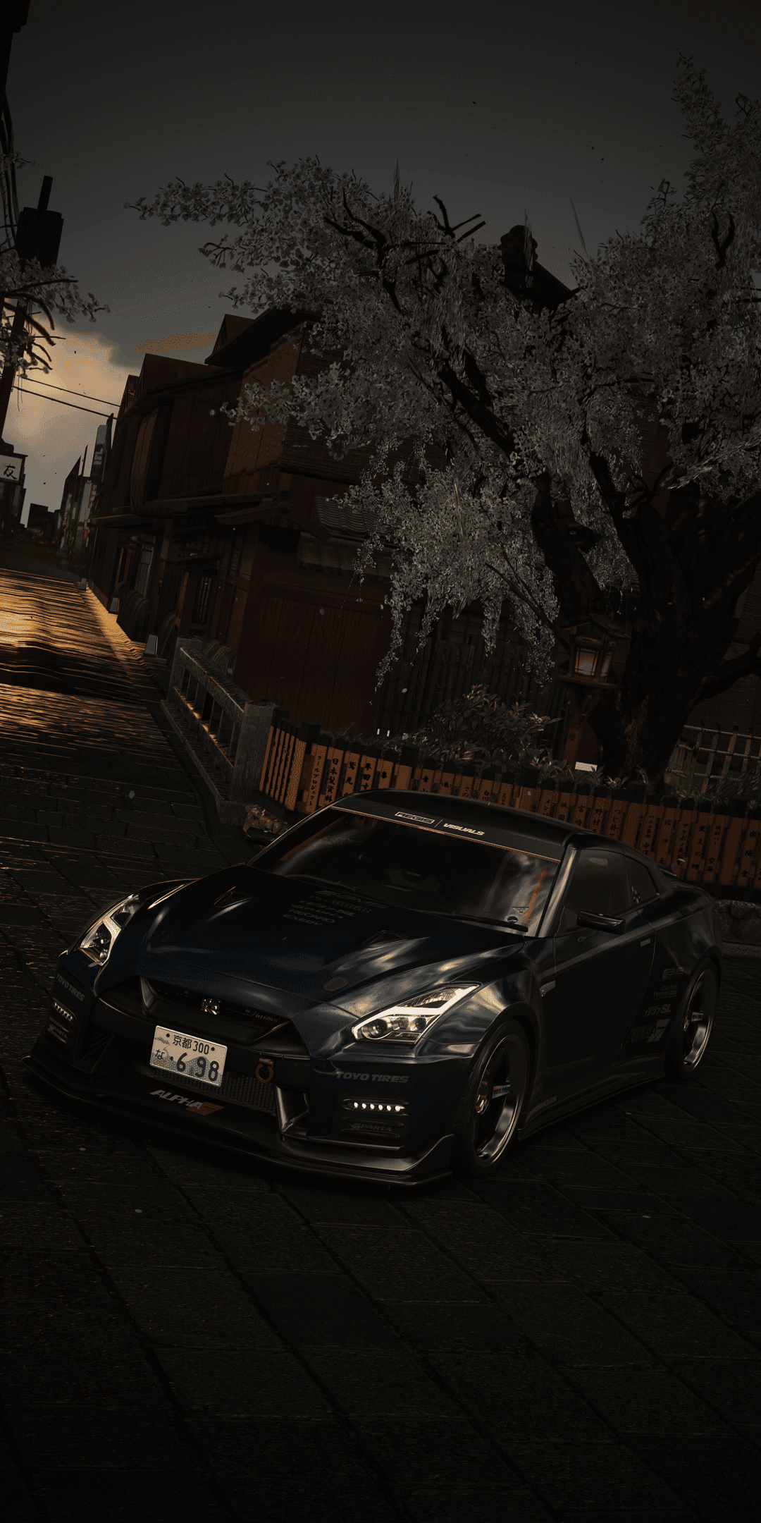Nissan GT-R sports car parked on a cobblestone street under white cherry blossoms during a blue hour twilight.