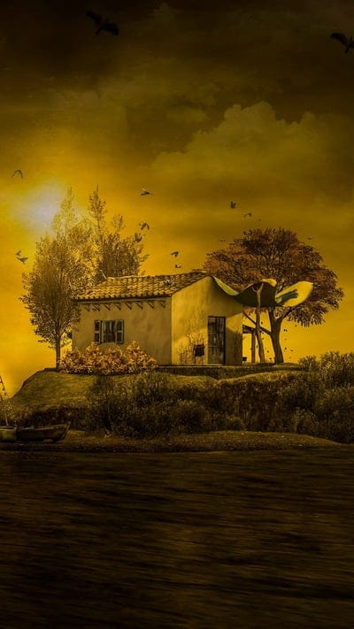 This surreal image portrays a small, rustic village bathed in an intense golden light, set against a dramatic and almost oppressive yellow-orange sky filled with dark, textured clouds. A lone house and several trees, some bare and some with autumn foliage, are central to the composition. Numerous birds fly across the sky, adding a sense of movement and scale, while a calm body of water in the foreground reflects the warm glow, creating a striking blend of beauty and impending atmosphere.