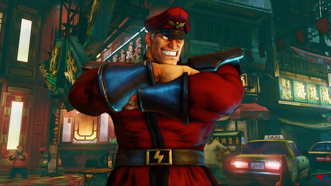 M. Bison in a red military uniform with silver gauntlets grins confidently in a neon-lit Chinatown street.