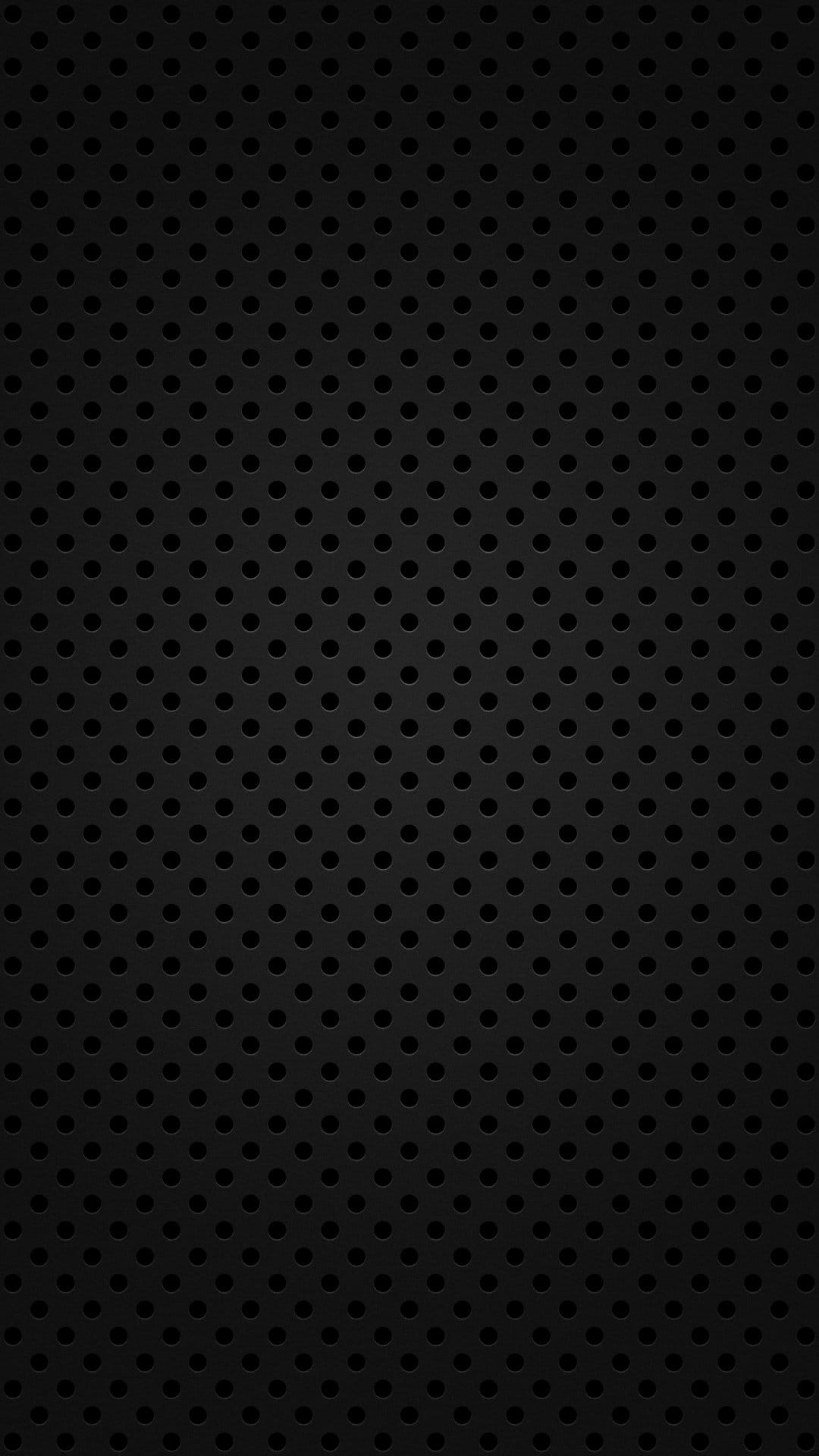 Matte black steel surface featuring a uniform pattern of small circular holes for an industrial look.