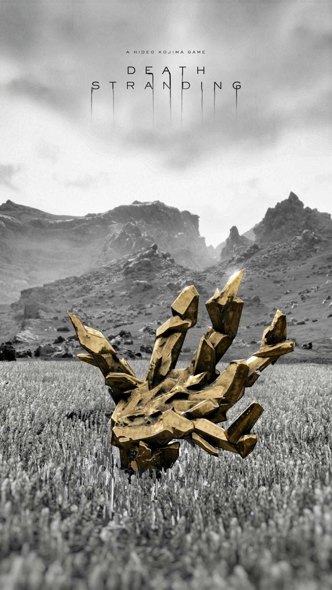 Golden hand-shaped chiral crystal emerging from a monochrome grass field with distant mountains and a cloudy sky.