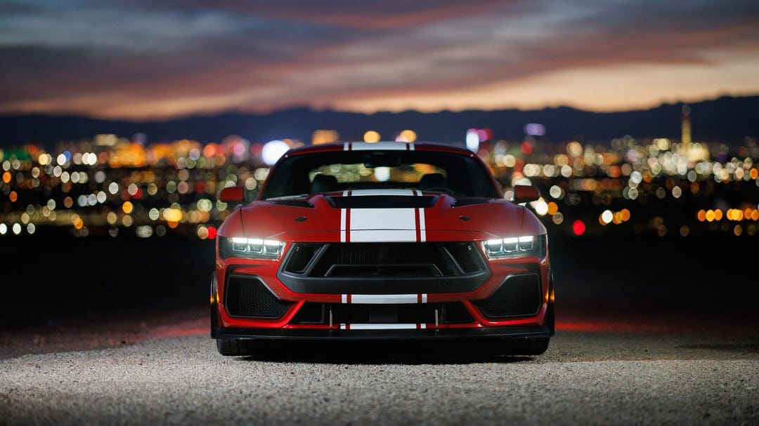 Shelby Super Snake muscle car showcasing metallic finish, carbon fiber hood vents, and sleek aerodynamic body.