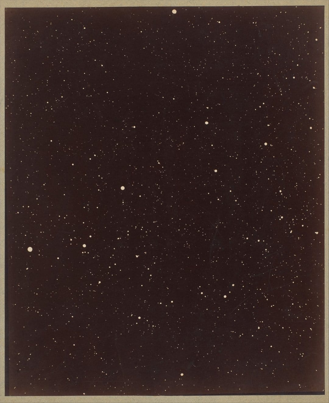 Countless luminous stars scatter across a grainy dark midnight sky in a portrait orientation celestial scene.