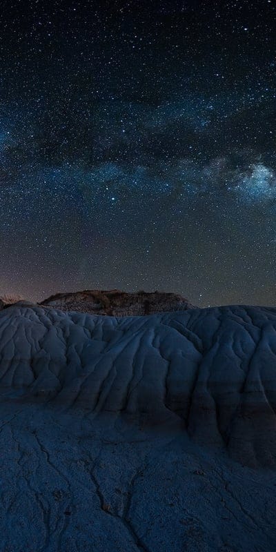 Milky Way, night sky, stars, desert, landscape, celestial, nature, cosmic, badlands, serene, tranquil, astronomy, dark sky, geological, peaceful, vibrant, mysterious, outdoor, beautiful, universe