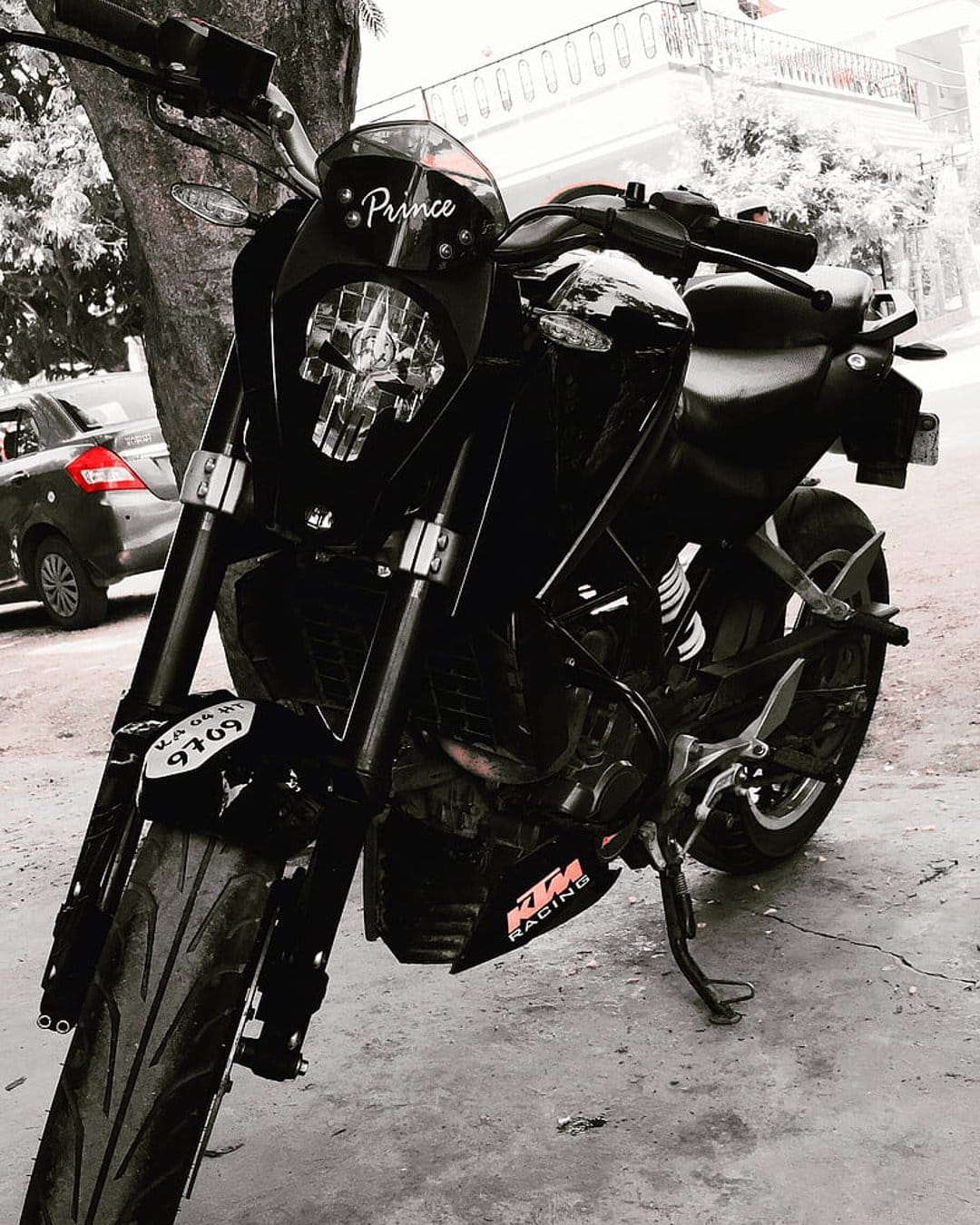 KTM Duke motorcycle in black and white featuring a Prince decal and number plate on the front headlight assembly.