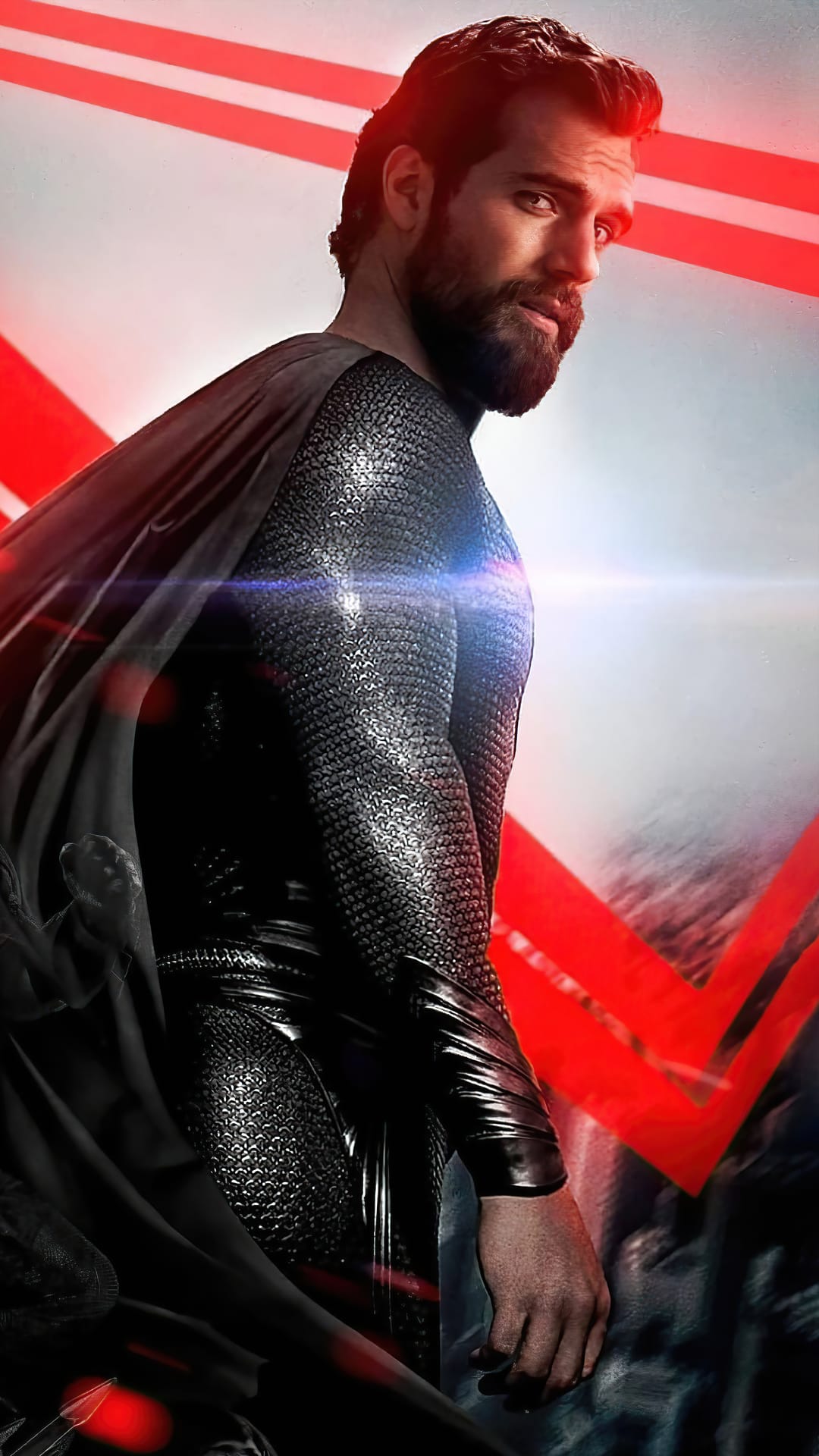 Henry Cavill as Superman in a black suit looking over his shoulder against a red and black abstract background.