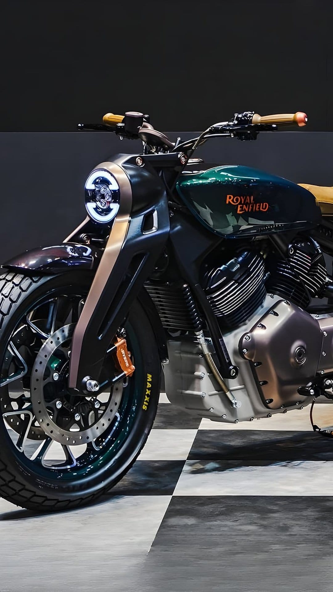 Royal Enfield custom motorcycle with a green fuel tank, LED headlight, and V-twin engine on a checkered floor.