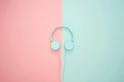 headphones, minimalist, music, audio, technology, design, color block, pink, teal, pastel, flat lay, studio shot, modern, clean, simple, background, object, equipment, sound, entertainment, lifestyle, vibrant, graphic