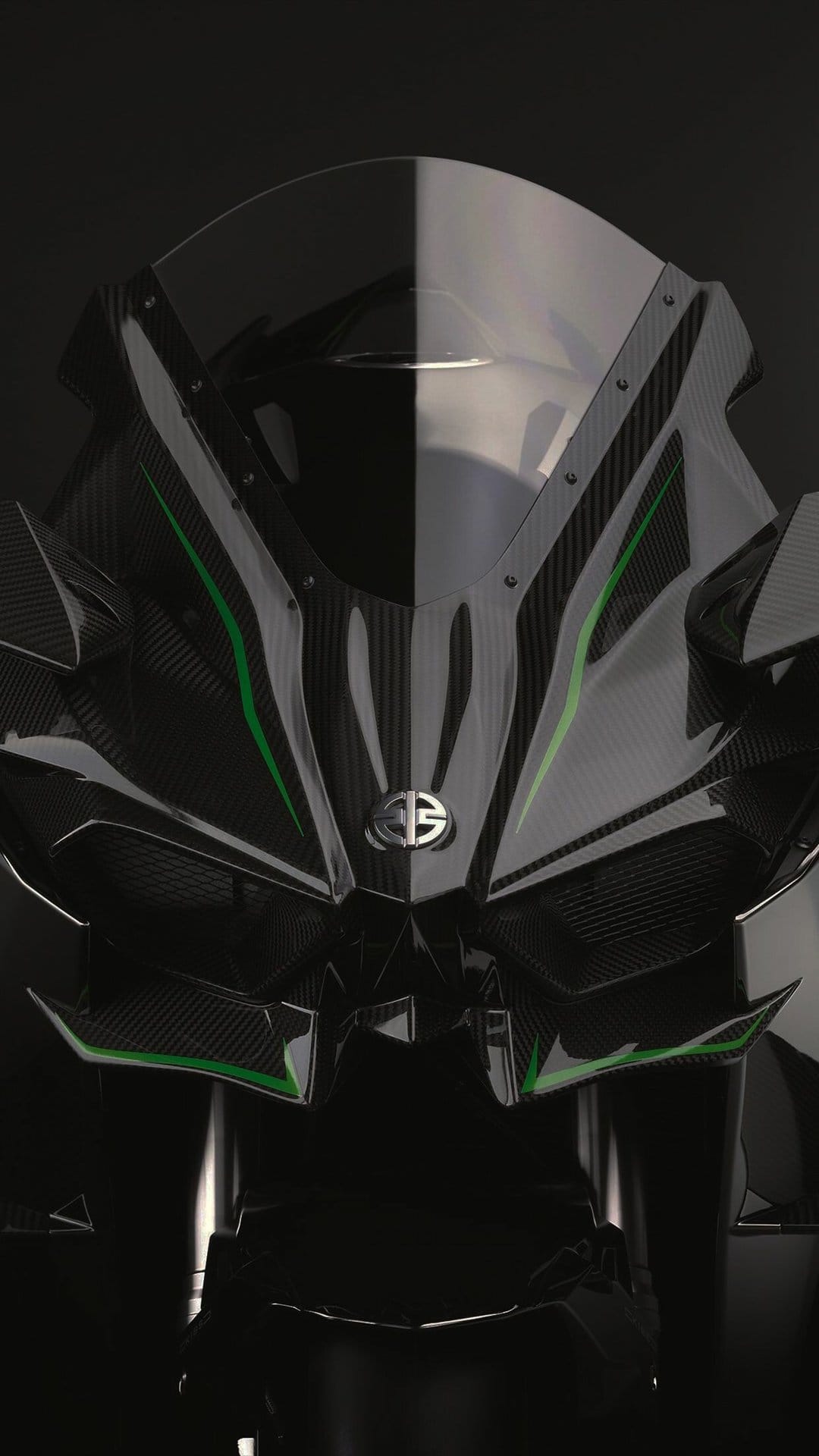 Front view of a dark carbon fiber motorcycle with green accents and a metallic logo under studio lighting.