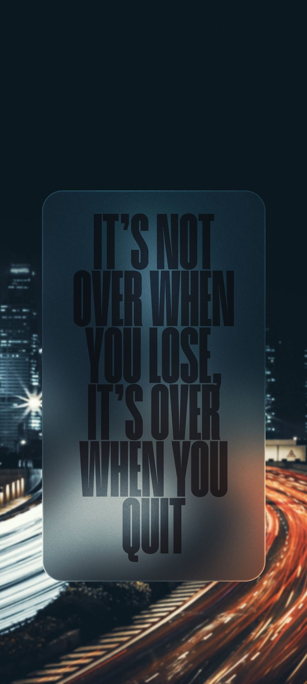 Inspirational quote text centered on a dark city street featuring vibrant yellow and orange bokeh light streaks.