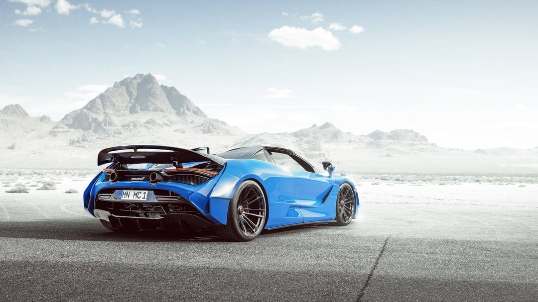 Blue widebody McLaren supercar parked on a desert flat with mountains under a bright, high-key sky.