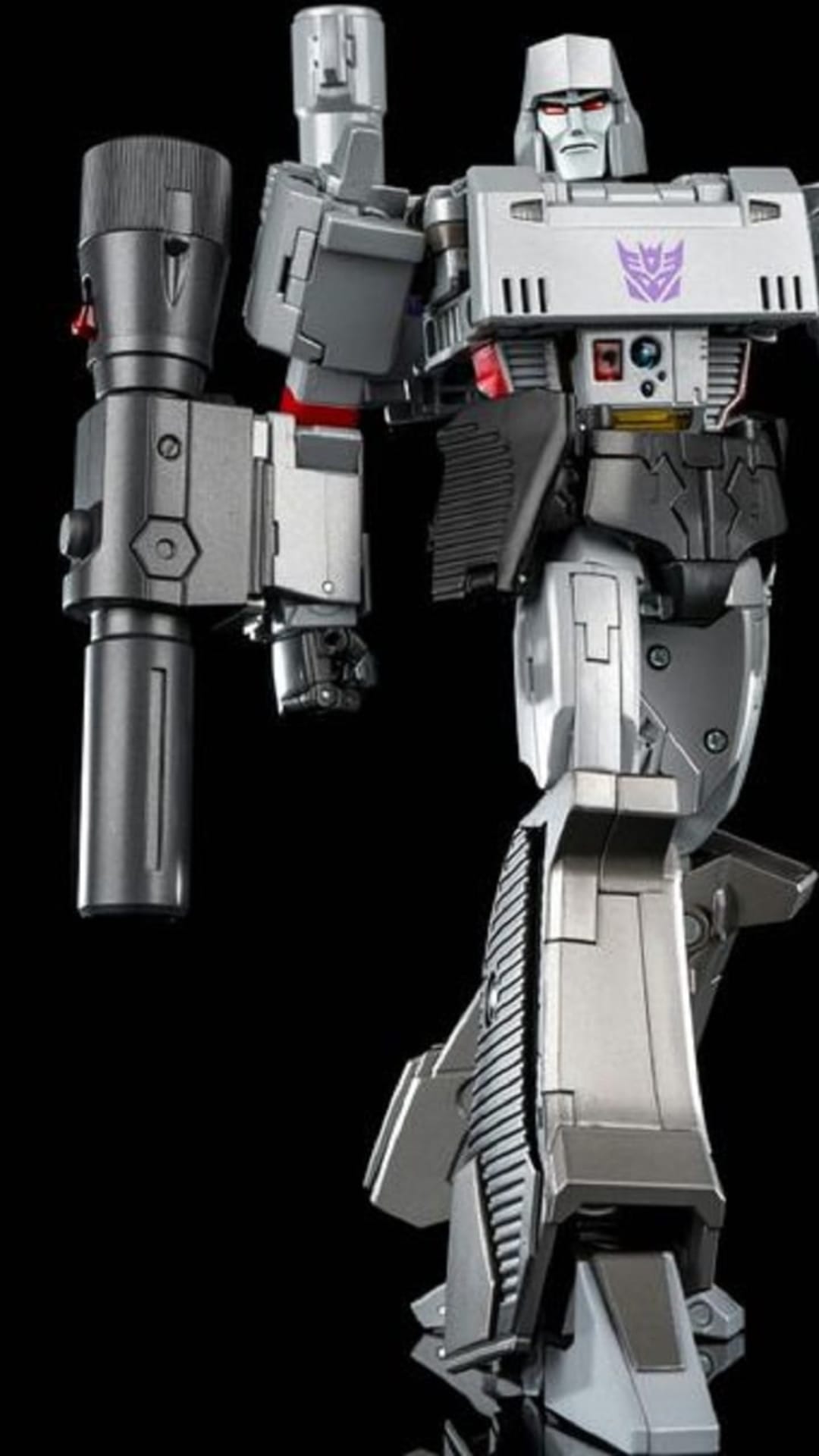 Megatron action figure with a fusion cannon and purple Decepticon logo stands against a solid black background.