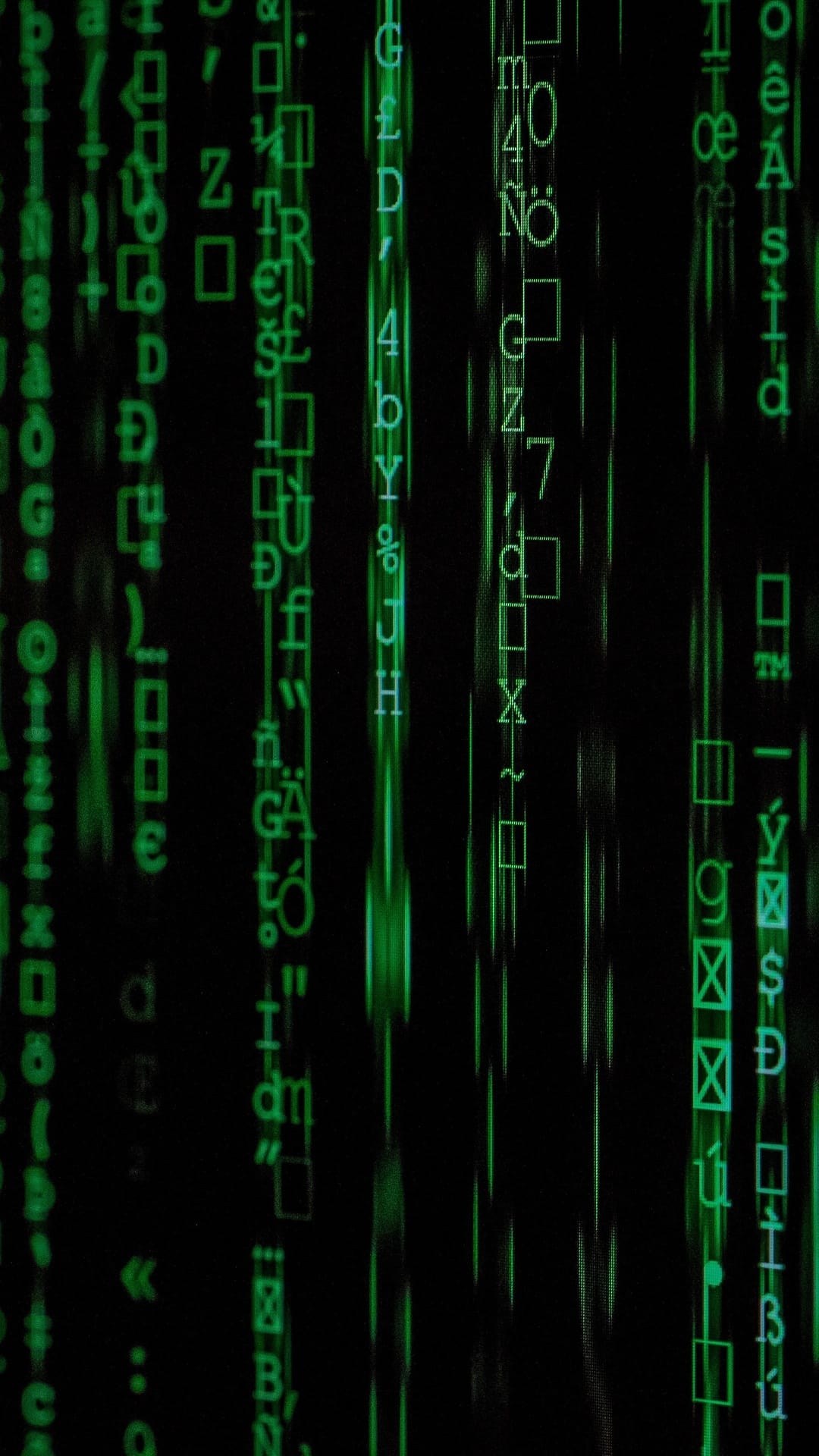 Green digital characters and symbols fall vertically against a black background in a cascading code pattern.