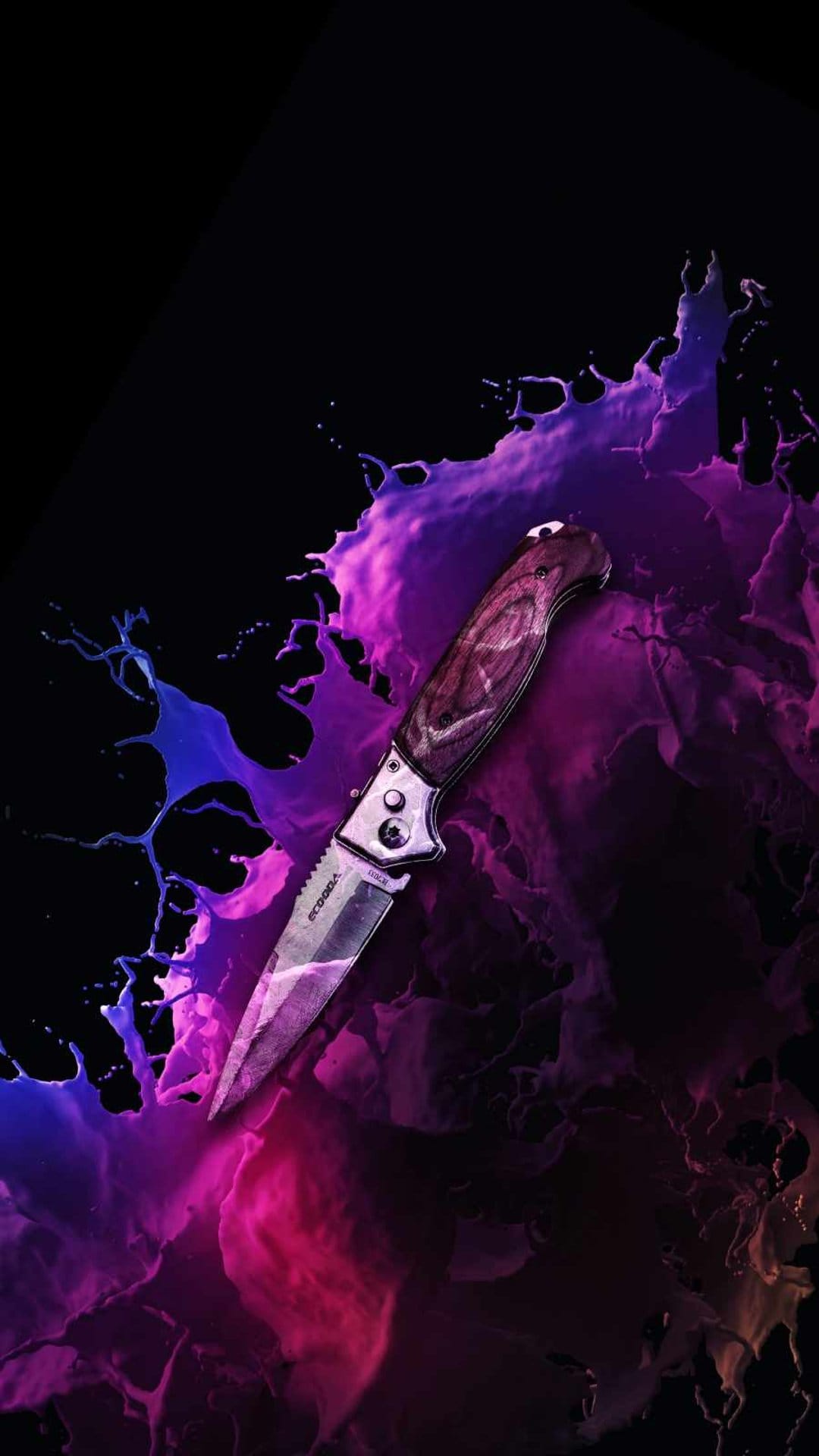 Folding knife with a wooden handle amidst purple and blue paint splashes on a dark black background.