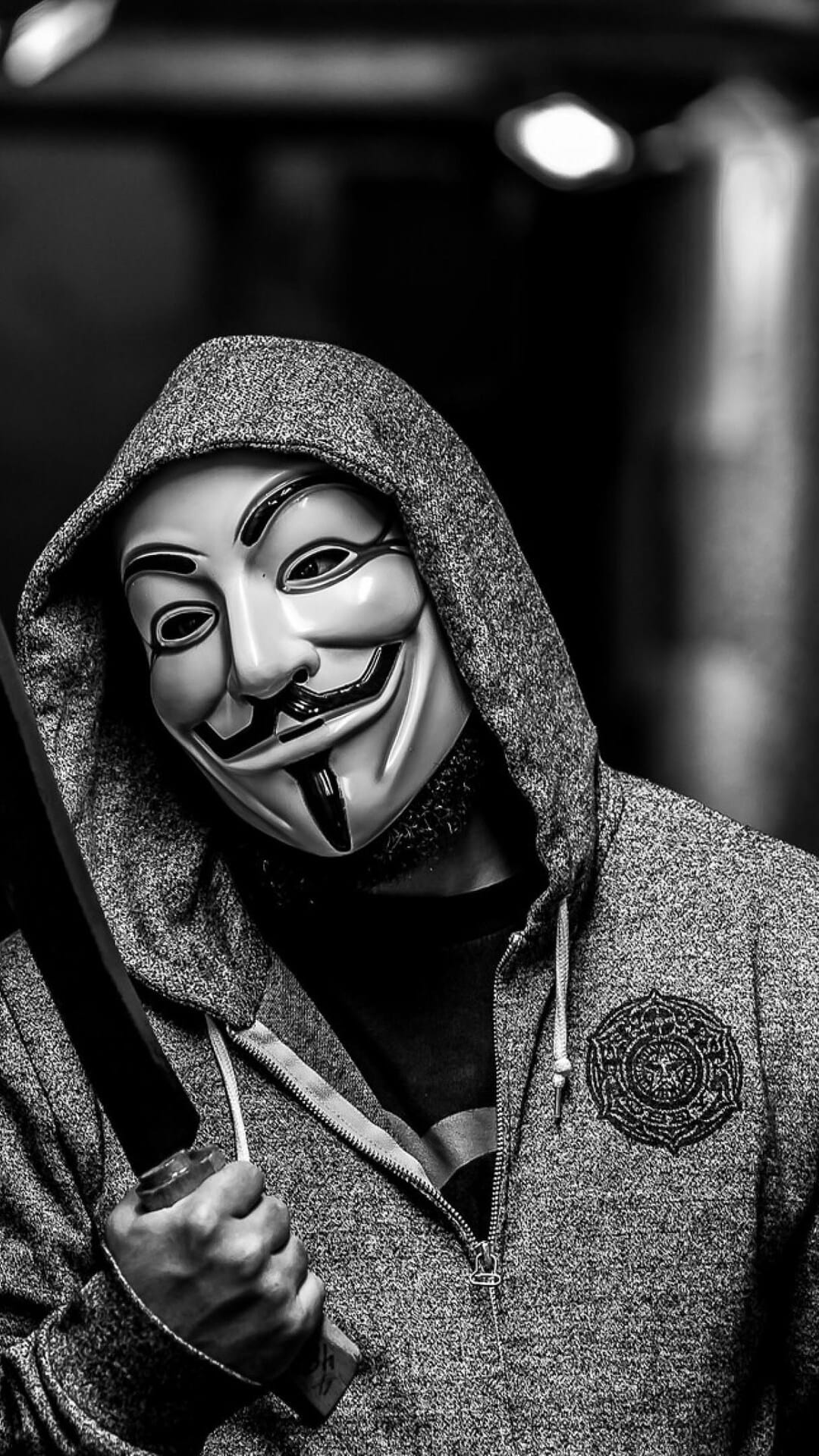 Guy Fawkes mask with a black mustache and rosy cheeks sits centered against a clean and solid white background.