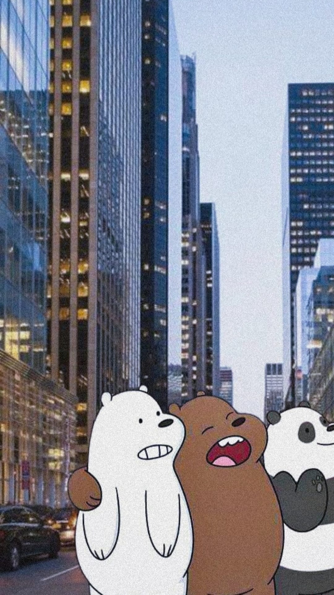 Grizz, Panda, and Ice Bear hugging on a city sidewalk with tall skyscrapers stretching into the sky behind them.
