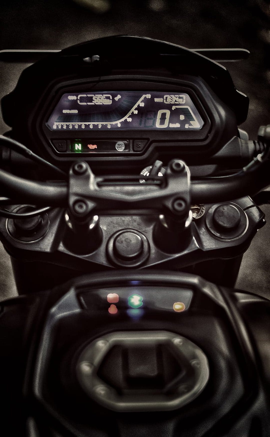 Digital motorcycle dashboard displaying a speedometer, gear indicator, and lit warning icons on a dark display.