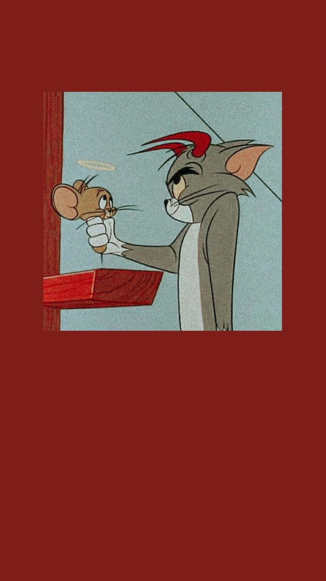 Tom Cat with red devil horns holds Jerry Mouse by the tail against a blue background and red wooden wall.