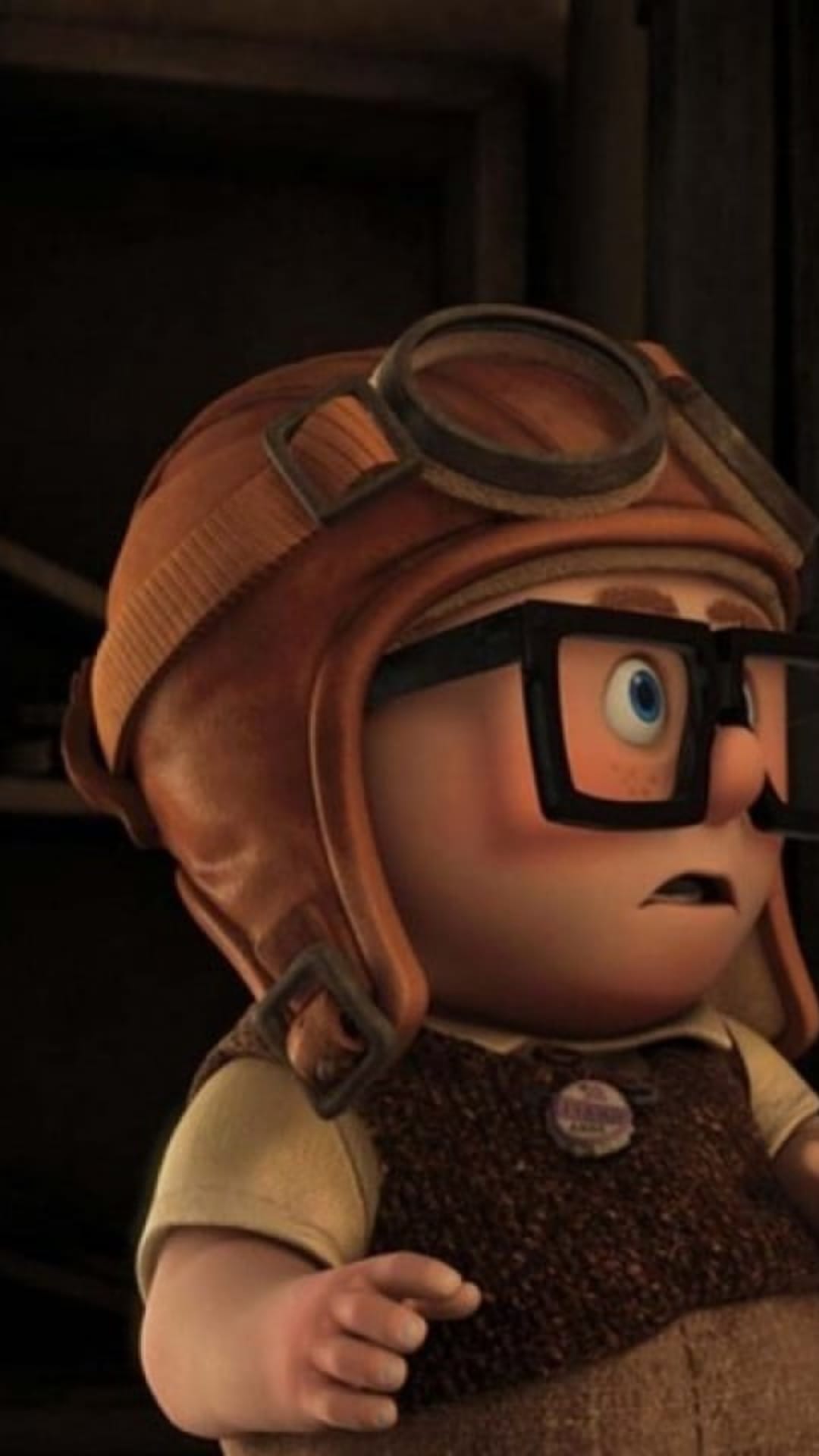 Russell from Up wears a leather aviator cap and thick glasses with a wide-eyed surprised facial expression.